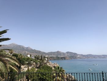 Scenic view of bay against clear blue sky