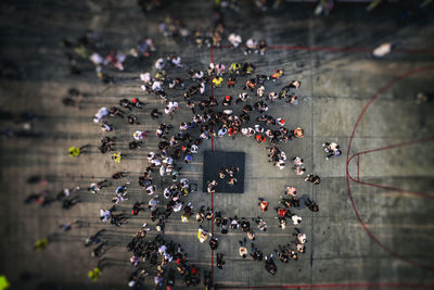Drone, high angle view from above of people gathering, walking on city street