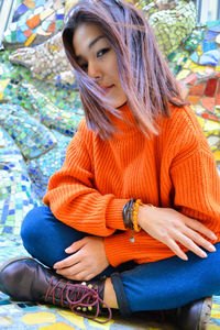 Portrait of young woman sitting outdoors