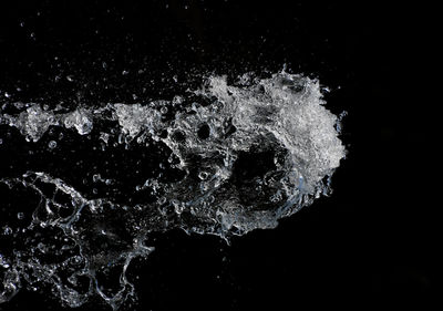 Blurred motion of water splashing on white background