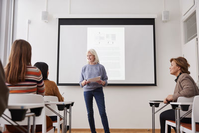 Woman giving presentation at seminar