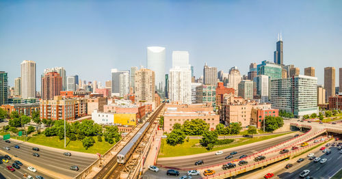 Aerial view of city street and buildings against sky