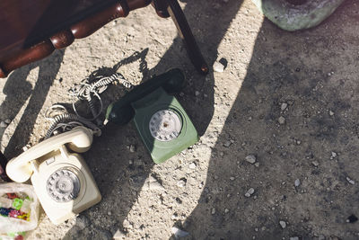 High angle view of vintage telephones on field