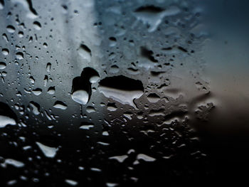 Full frame shot of raindrops on glass window