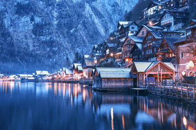 Scenic view of old houses near lake against the mountain