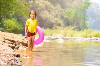 Portrait of smiling girl standing in lake