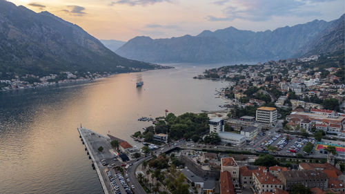 High angle view of townscape by mountains against sky