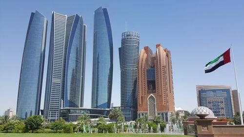 Low angle view of modern buildings against clear blue sky