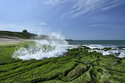 Scenic view of sea and shore against sky