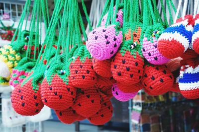 Close-up of multi colored crochets hanging for sale in market