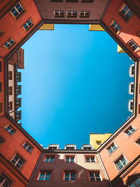 Low angle view of buildings against blue sky