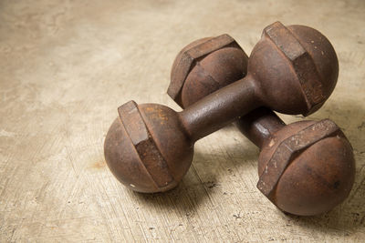 High angle view of rusty dumbbells on table