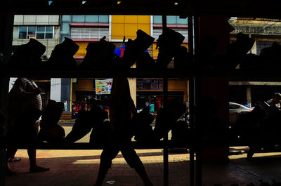 Silhouette people walking in store