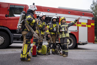 Firefighters team in front of fire engine