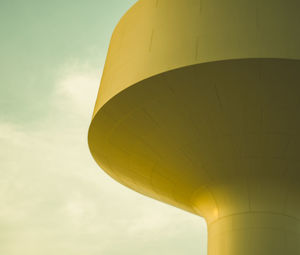 Low angle view of yellow tower against sky