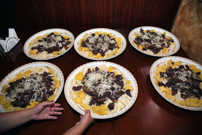 High angle view of hand holding food on table