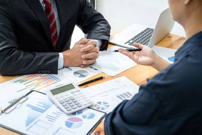 Midsection of business colleagues working at office