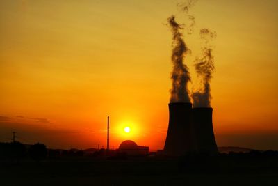 Smoke emitting from chimney against sky during sunset