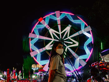 Low angle view of illuminated ferris wheel at night