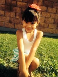 Portrait of a smiling girl sitting on grass