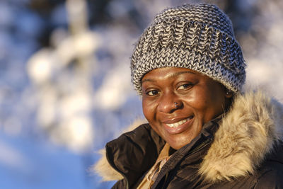 African woman outside during a sunny cold winter day in the swedish nature.