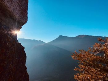 Scenic view of mountains against clear blue sky