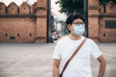 Man wearing mask standing outdoors