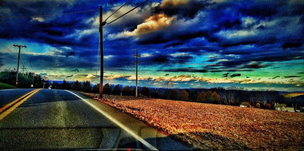 View of road against cloudy sky