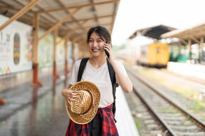 Portrait of young woman using mobile phone
