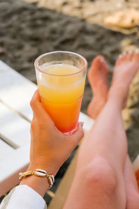 Midsection of woman holding drink