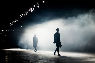 Silhouette models walking on stage