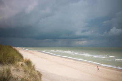 High angle view of boy walking at beach