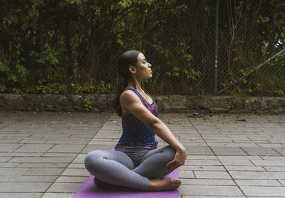 Women making yoga on the park