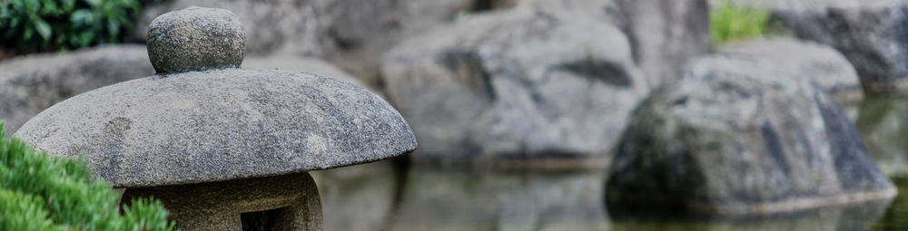 Close-up of wooden post on rock