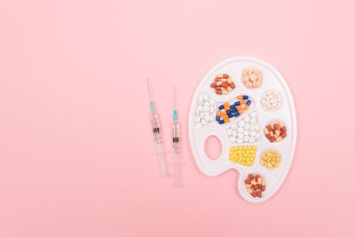 Directly above shot of multi colored candies against pink background