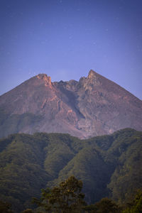 Scenic view of mountains against clear blue sky