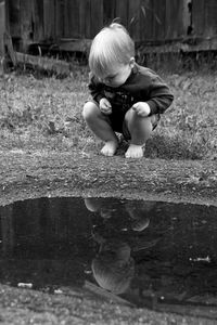 Boy playing in puddle