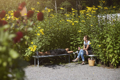 Florists resting on benches by plants