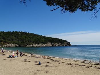 Scenic view of beach against clear blue sky