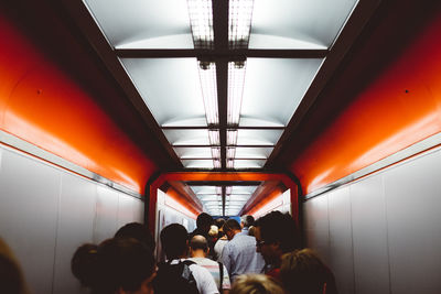 Crowd walking in illuminated airport