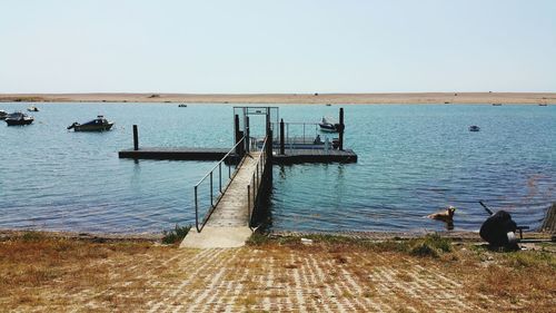 Pier on sea against clear sky