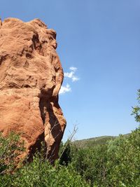 Scenic view of cliff against clear blue sky