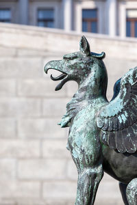 Close-up of horse statue against building