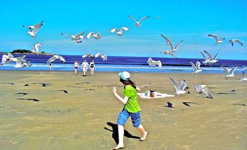 Woman jumping on beach