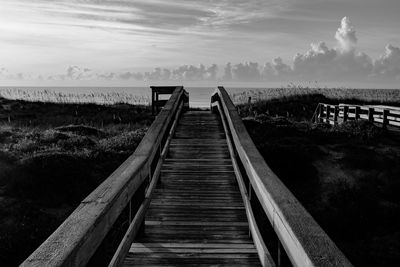 Wooden pier leading to sea