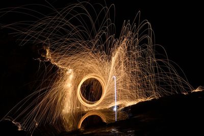 Firework display against sky at night