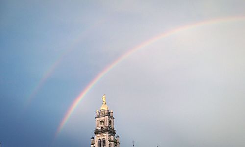 Low angle view of rainbow over buildings