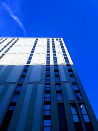 Low angle view of modern building against blue sky