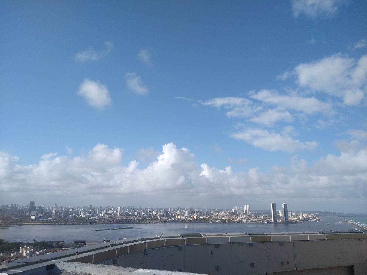 SCENIC VIEW OF SEA AGAINST SKY IN CITY