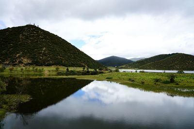 Scenic view of lake and mountains against sky